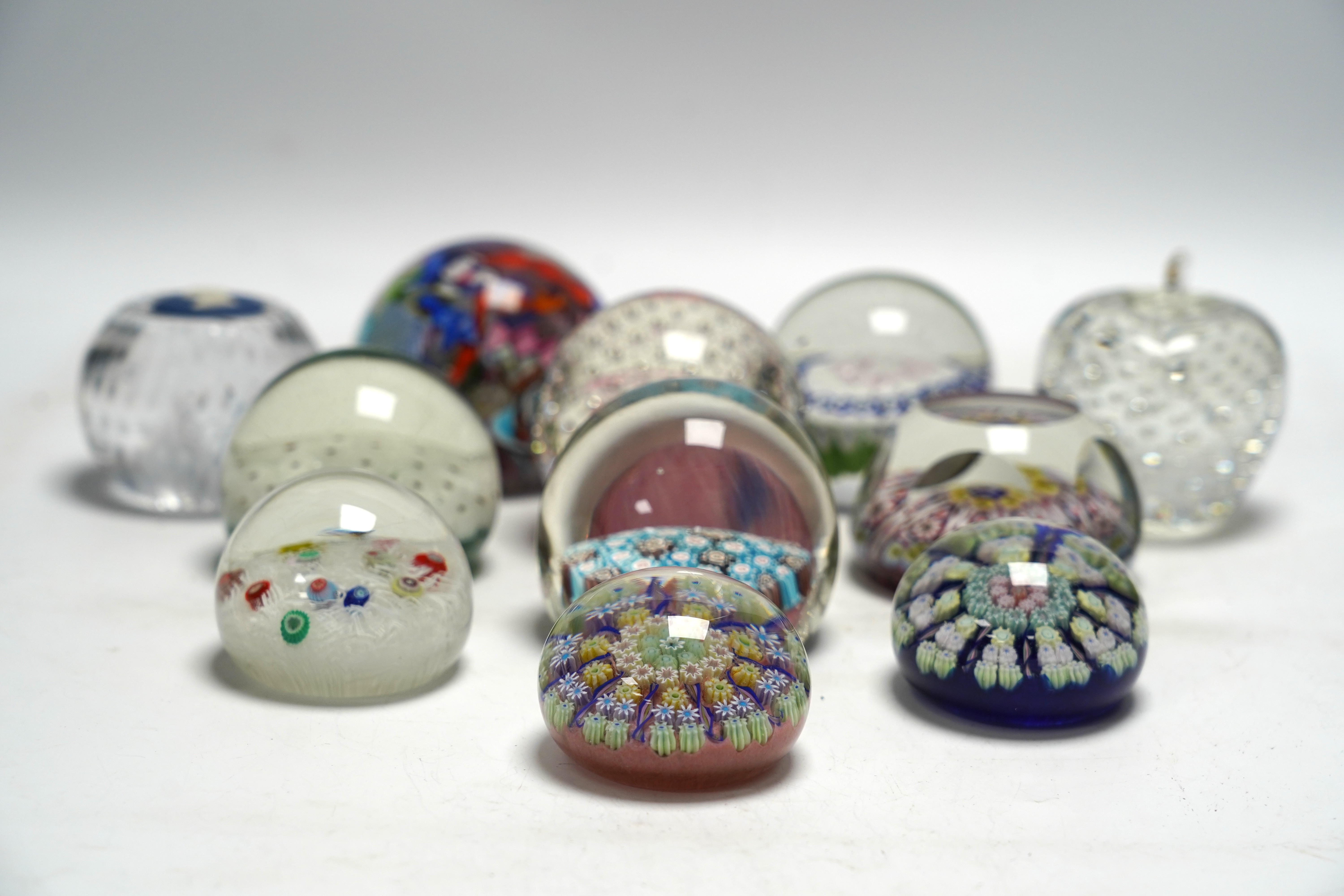 Eleven mixed Scottish and other glass paperweights including Caithness, largest 8.5cm in diameter